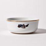 Back of shaving bowl with illustration of vintage captain's hat, sextant, and coiled rope