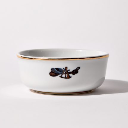 Back of shaving bowl with illustration of vintage captain's hat, sextant, and coiled rope