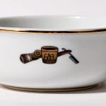 Detail view of back of shaving bowl with illustration of vintage shaving mug, brush, and straight razor