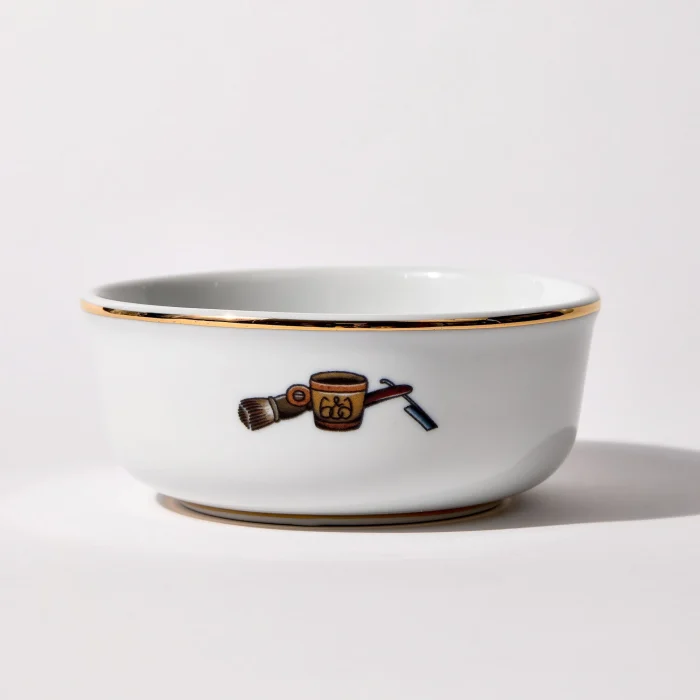 Back of shaving bowl with illustration of vintage shaving mug, brush, and straight razor