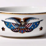 Detail view of porcelain shaving bowl with vintage-style eagle and American flag illustration, gold trim