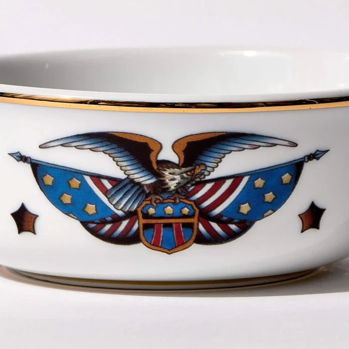 Detail view of porcelain shaving bowl with vintage-style eagle and American flag illustration, gold trim