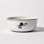 Back of shaving bowl with illustration of vintage top hat, cane, monocle