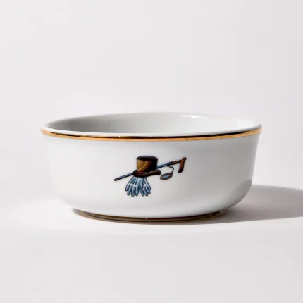 Back of shaving bowl with illustration of vintage top hat, cane, monocle