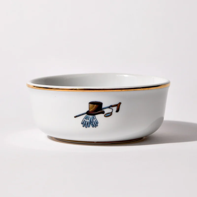 Back of shaving bowl with illustration of vintage top hat, cane, monocle