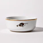 Back of shaving bowl with illustration of vintage fishing creel, fish, rod, and reel