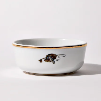 Back of shaving bowl with illustration of vintage fishing creel, fish, rod, and reel