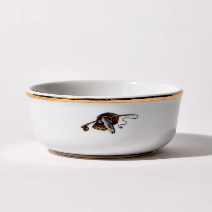 Back of shaving bowl with illustration of vintage fishing creel, fish, rod, and reel