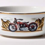 Detail view of porcelain shaving bowl with illustration of vintage Harley-Davidson motorcycle and desert backdrop, gold trim