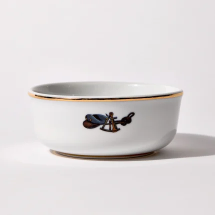 Back of shaving bowl with illustration of vintage captain's hat, sextant, and coiled rope